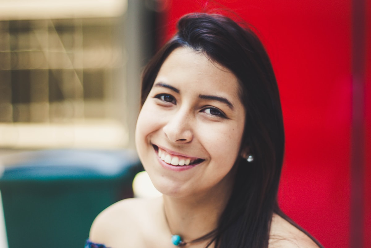 A person showing a natural smile in a close-up portrait